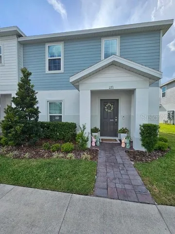 a front view of house with yard and green space