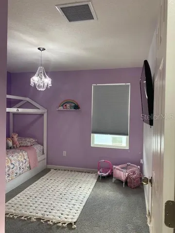 a bedroom with a bed and a flat tv screen