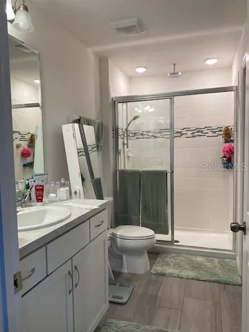 a bathroom with a sink toilet and shower