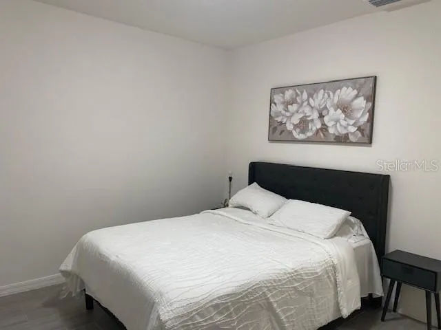 a bedroom with a bed and wall painting