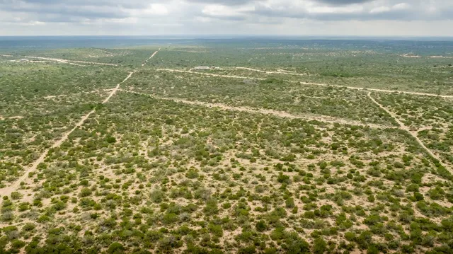 a view of a field with an outdoor space