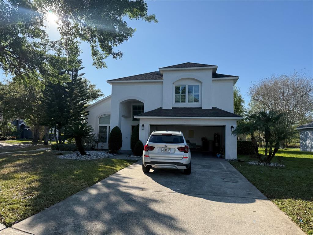 a car parked in front of white house