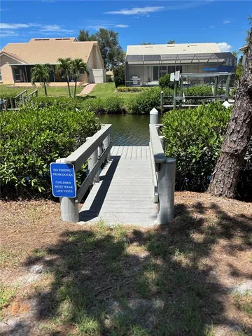 a view of a patio with table and chairs and potted plants