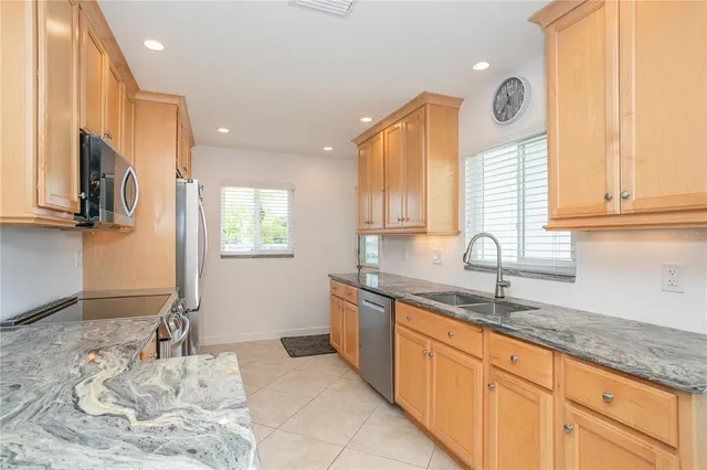 a bedroom with a bed a dresser and a chandelier