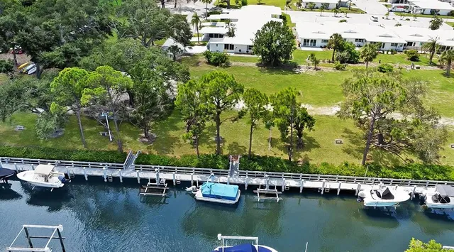 an aerial view of a house yard swimming pool and outdoor seating