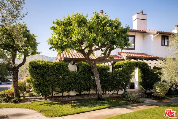 a view of a house with yard and tree s