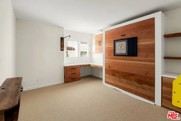 a view of an empty room with a fireplace and a window