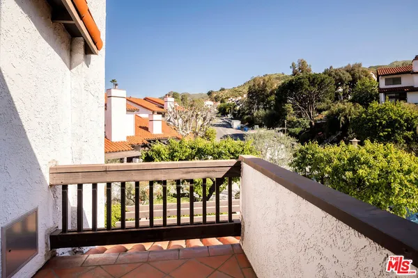 a view of a balcony with wooden floor and outdoor space