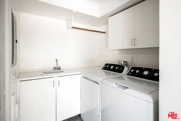 a kitchen with a sink a stove and cabinets