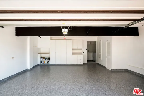 a utility room with a sink and mirror