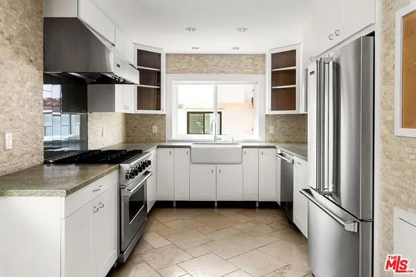 a kitchen with a sink stove and refrigerator