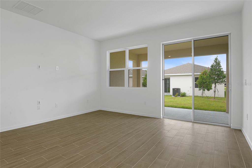 236 Flag Lilly Lane Umatilla, FL 32784 - Photo 11 of 25 a view of an empty room with a window