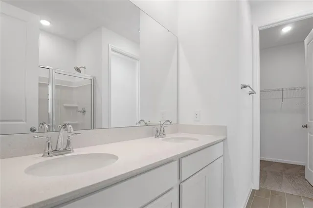 a bathroom with double sink and a mirror