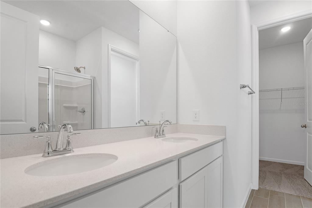 236 Flag Lilly Lane Umatilla, FL 32784 - Photo 15 of 25 a bathroom with double sink and a mirror