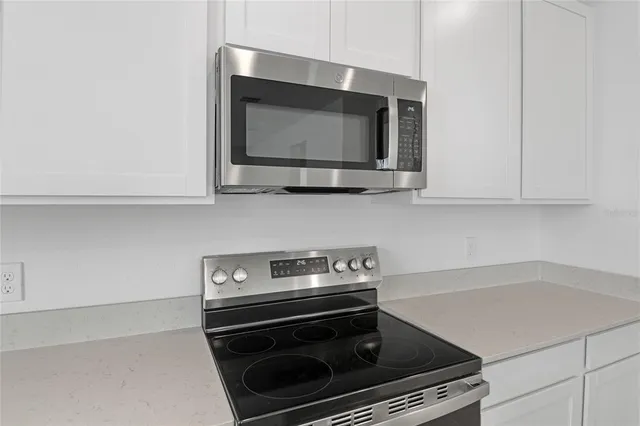 a kitchen with a stove and a microwave