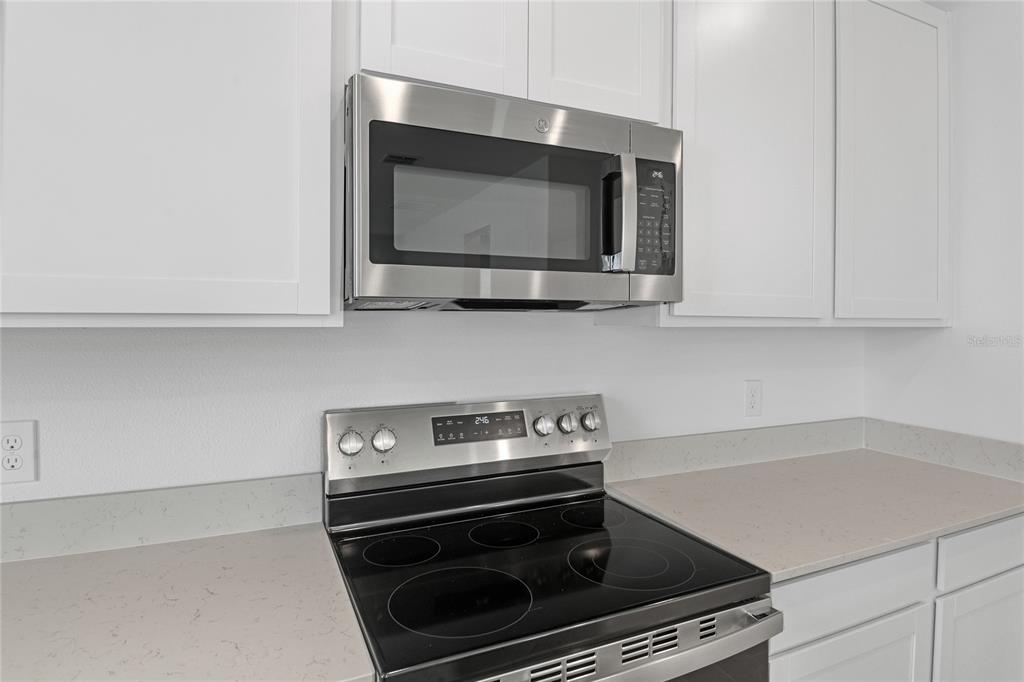 236 Flag Lilly Lane Umatilla, FL 32784 - Photo 8 of 25 a kitchen with a stove and a microwave