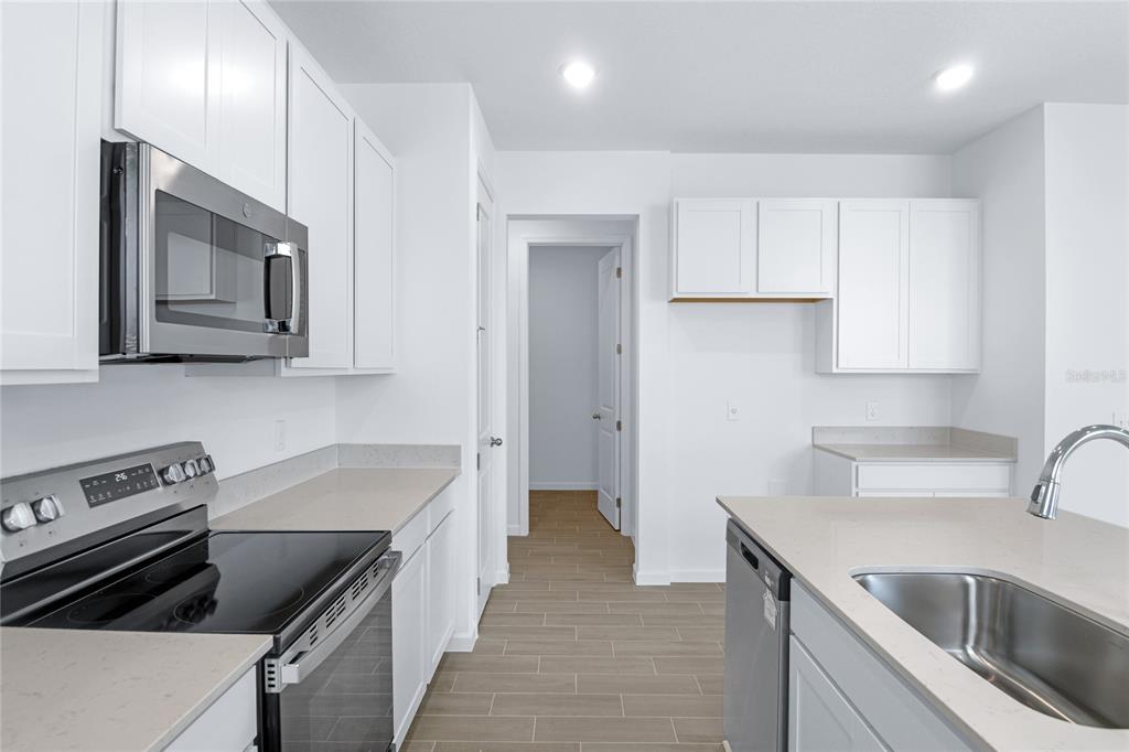 236 Flag Lilly Lane Umatilla, FL 32784 - Photo 9 of 25 a kitchen that has a sink and a stove