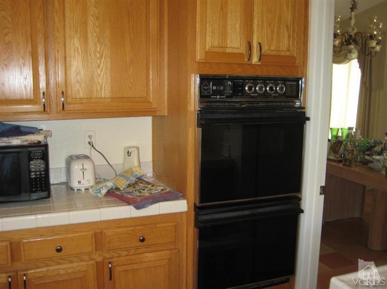 12491 Spring Creek Road Moorpark, CA 93021 - Photo 4 of 4 a kitchen with granite countertop a refrigerator stove and sink
