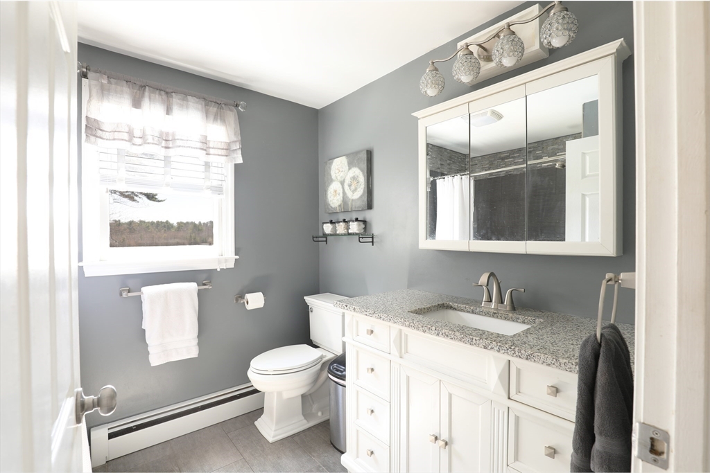 40 Pine Street Carver, MA 02330 - Photo 13 of 30 a bathroom with a granite countertop toilet sink and mirror