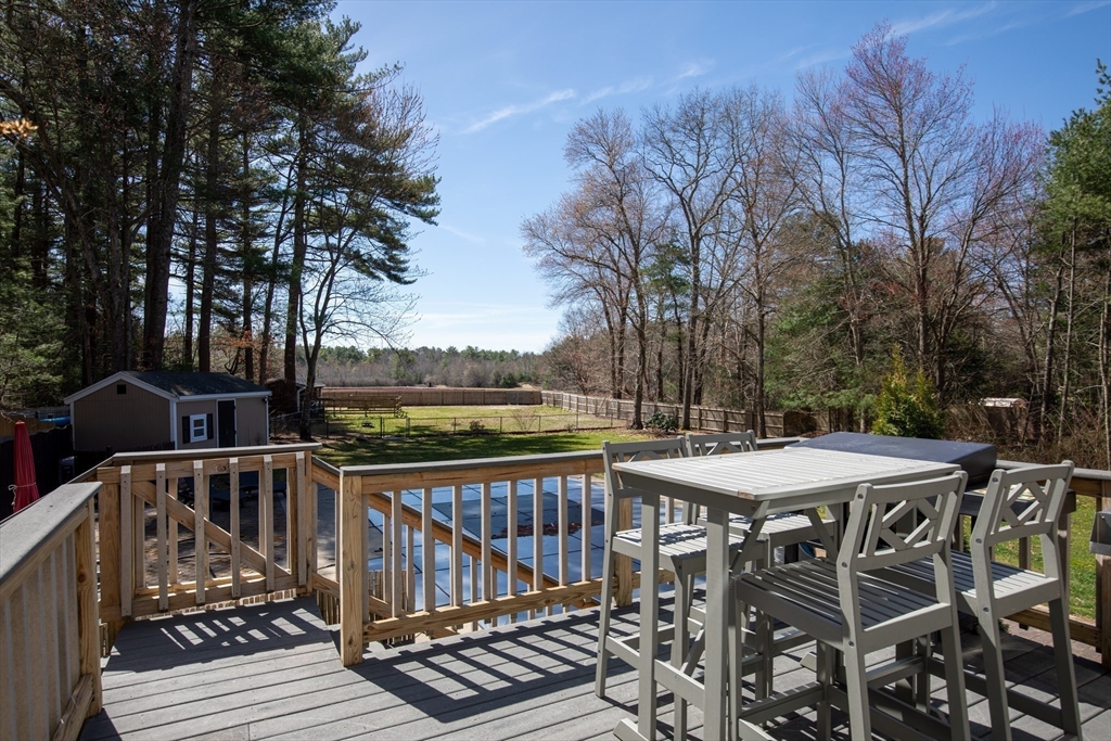 40 Pine Street Carver, MA 02330 - Photo 19 of 30 a view of a roof deck with table and chairs and wooden floor