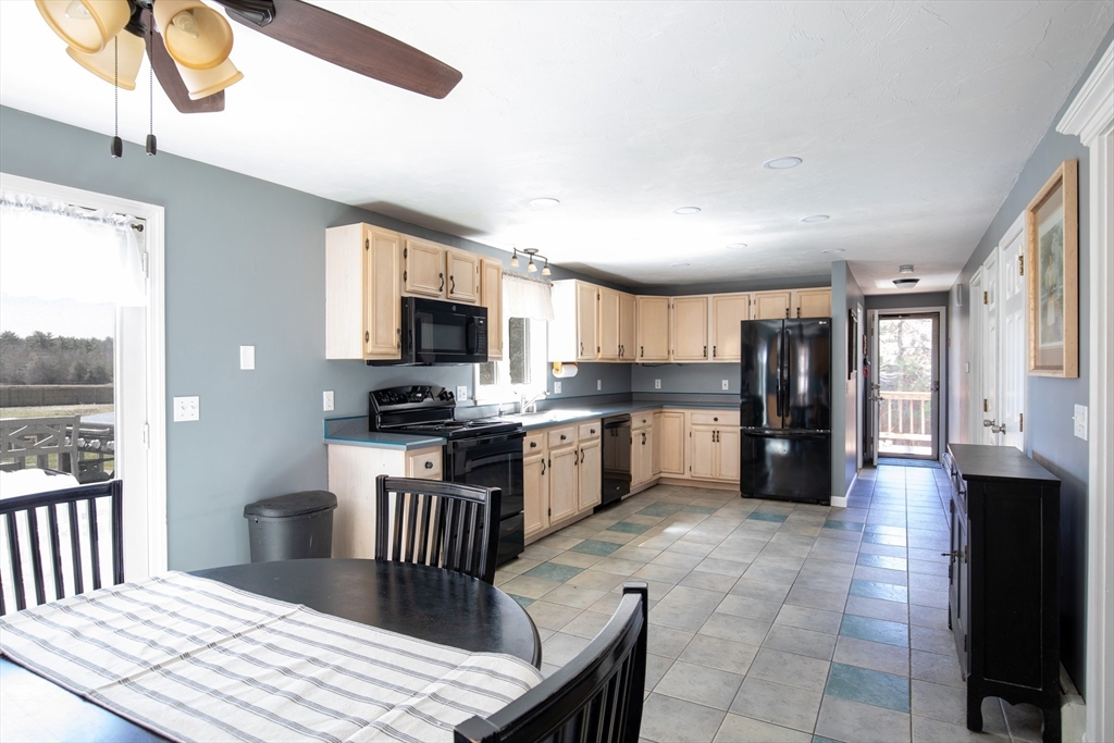 40 Pine Street Carver, MA 02330 - Photo 3 of 30 a large kitchen with kitchen island granite countertop a stove top oven a sink a counter space and cabinets