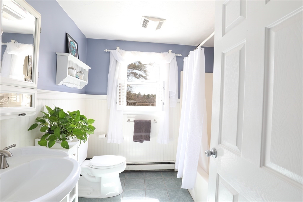 40 Pine Street Carver, MA 02330 - Photo 9 of 30 a white toilet sitting next to a bathroom sink and tub