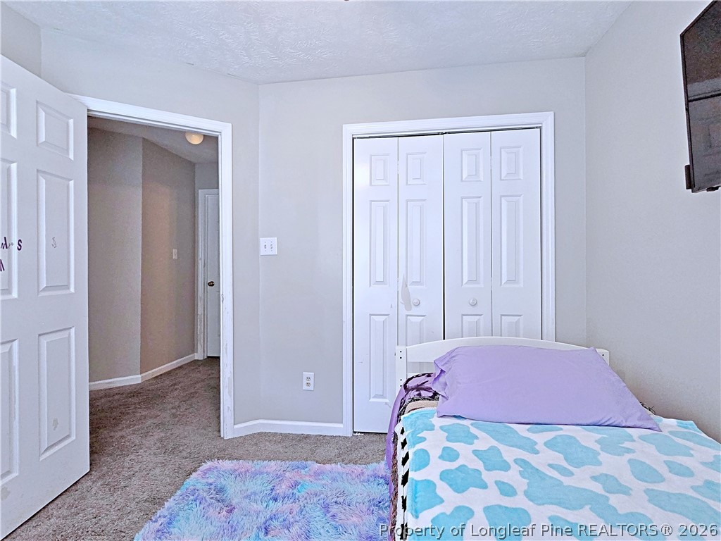5218 Pringle Way Hope Mills, NC 28348 - Photo 32 of 43 a bedroom with a bed and a cabinets
