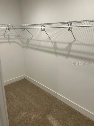 a bathroom with a granite countertop sink a mirror and a bathtub