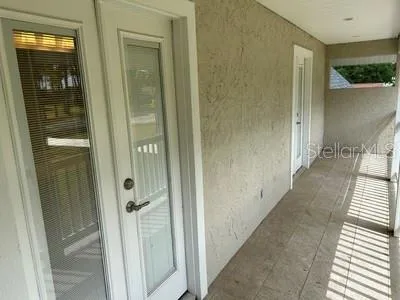 a view of balcony with two chairs and wooden floor