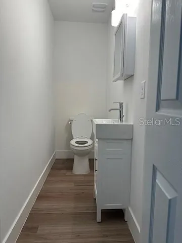 a bathroom with a sink toilet and vanity