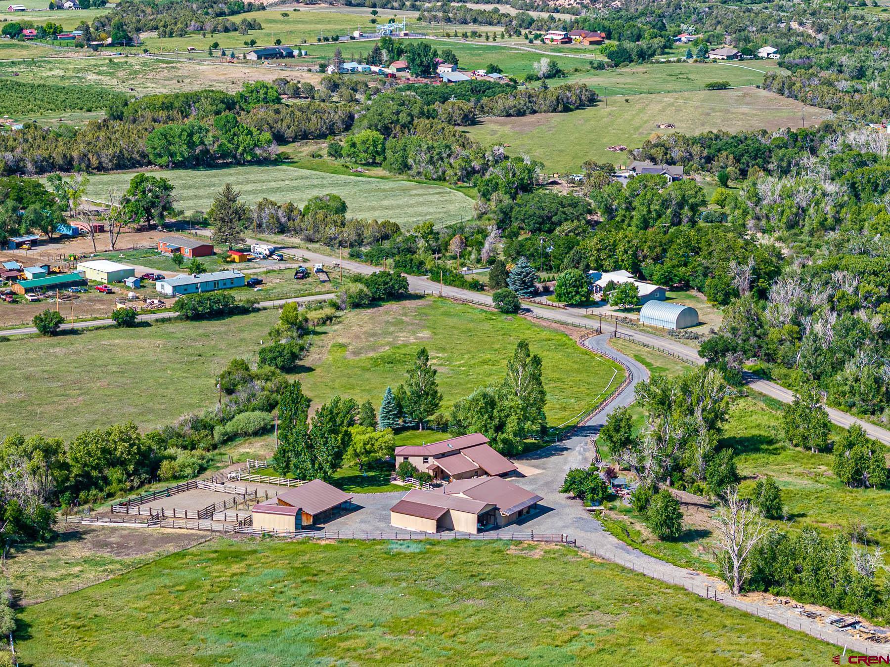 19550 2325th Road Cedaredge, CO 81413 - Photo 1 of 45 an aerial view of a house with a garden and lake view