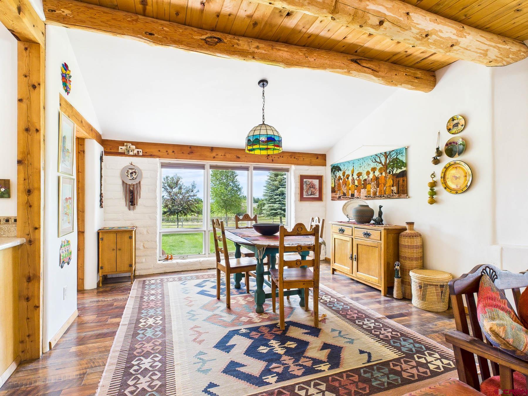 19550 2325th Road Cedaredge, CO 81413 - Photo 13 of 45 a dining room with furniture chandelier and wooden floor