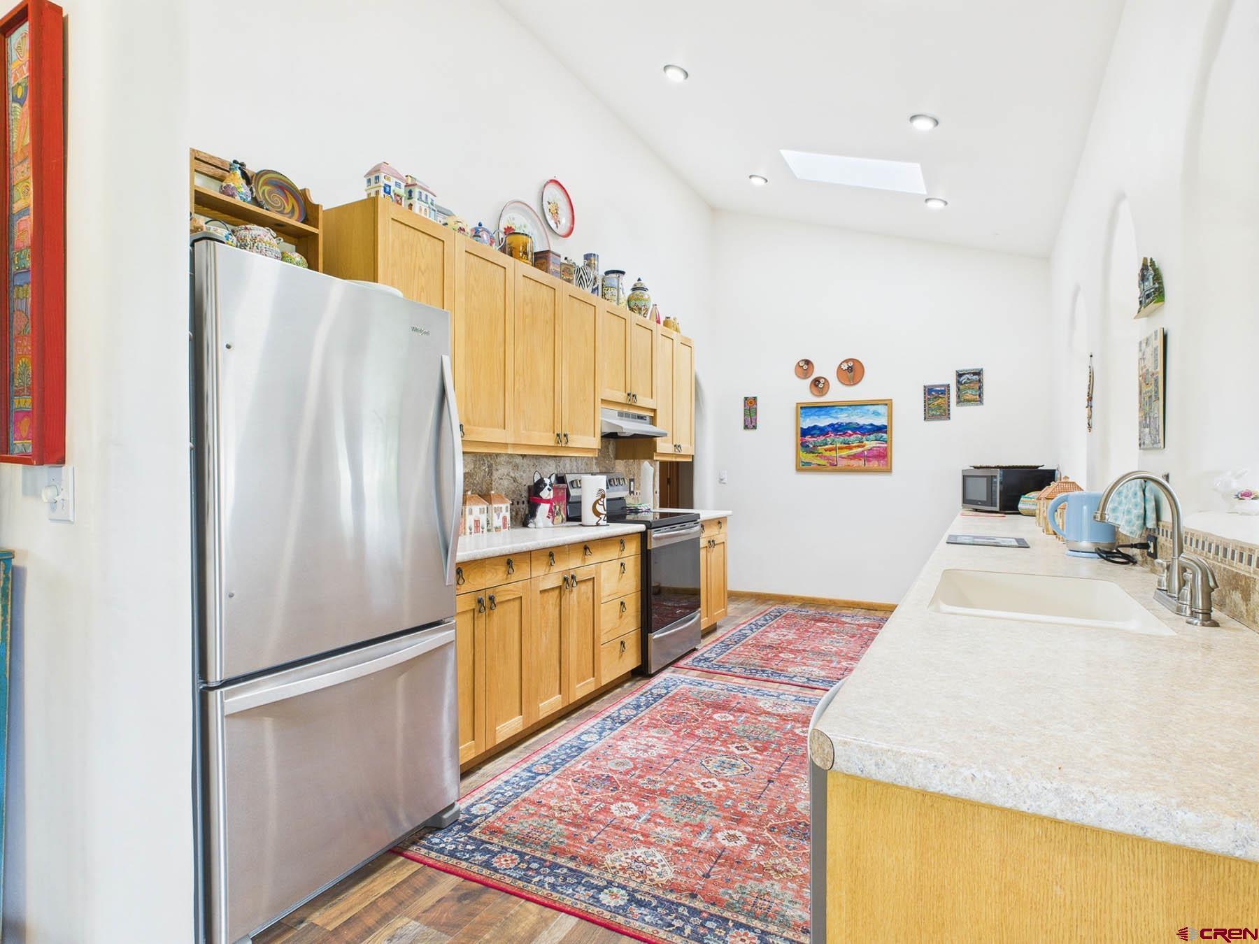 19550 2325th Road Cedaredge, CO 81413 - Photo 17 of 45 a kitchen with a refrigerator and a sink