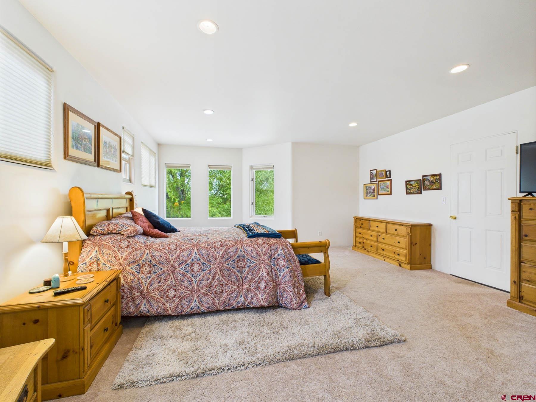 19550 2325th Road Cedaredge, CO 81413 - Photo 23 of 45 a bedroom with a bed and wooden floor