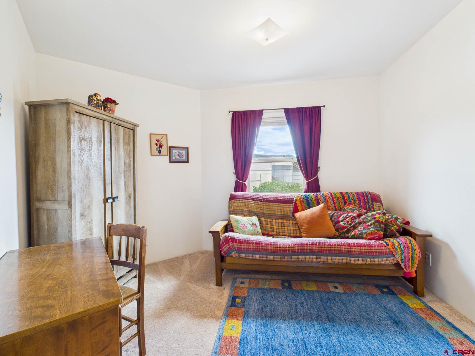 19550 2325th Road Cedaredge, CO 81413 - Photo 27 of 45 a living room with furniture and a window