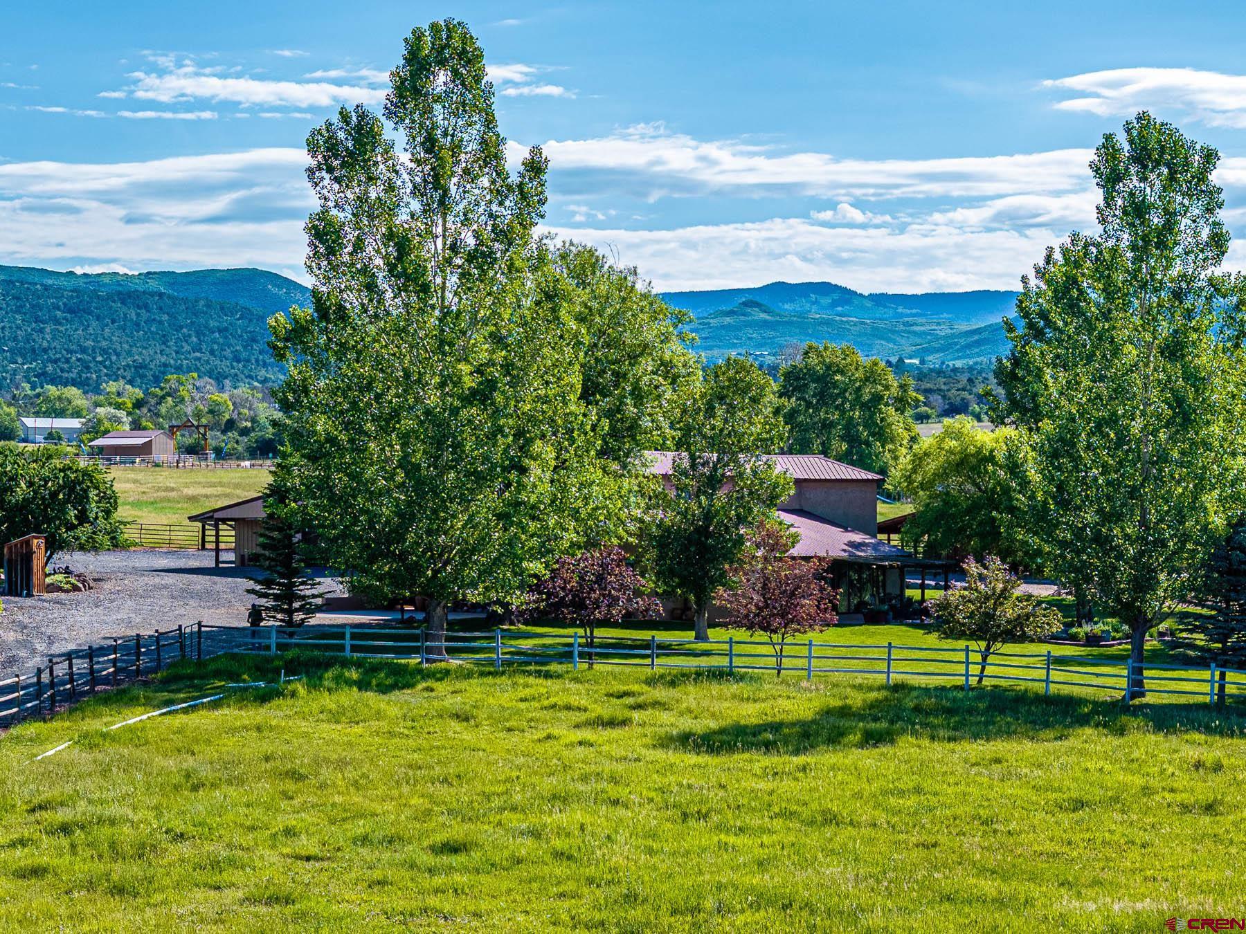 19550 2325th Road Cedaredge, CO 81413 - Photo 3 of 45 a view of a golf course with a lake view