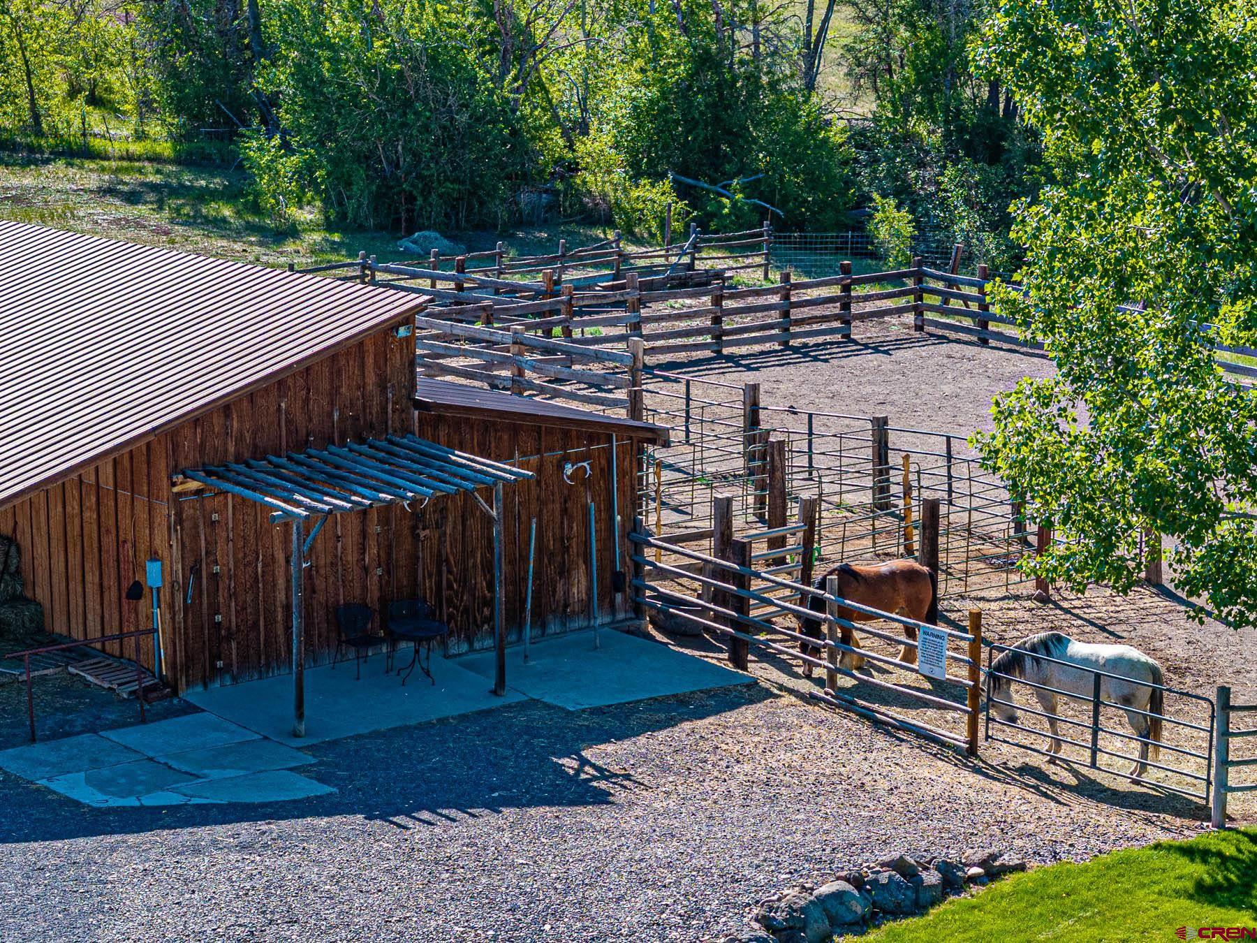 19550 2325th Road Cedaredge, CO 81413 - Photo 33 of 45 a view of a patio with table and chairs a barbeque with wooden fence