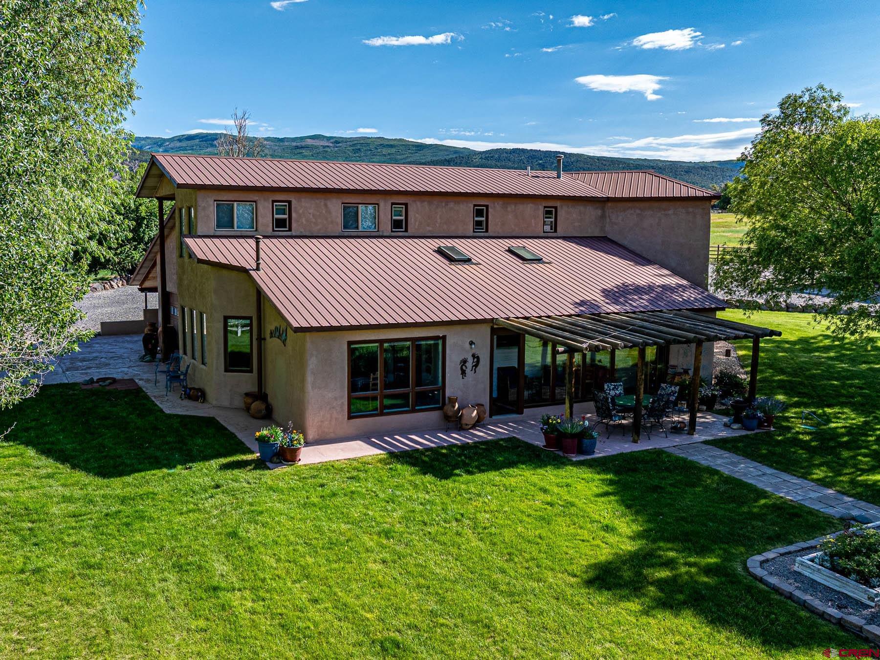19550 2325th Road Cedaredge, CO 81413 - Photo 7 of 45 a view of a house with a yard balcony and furniture