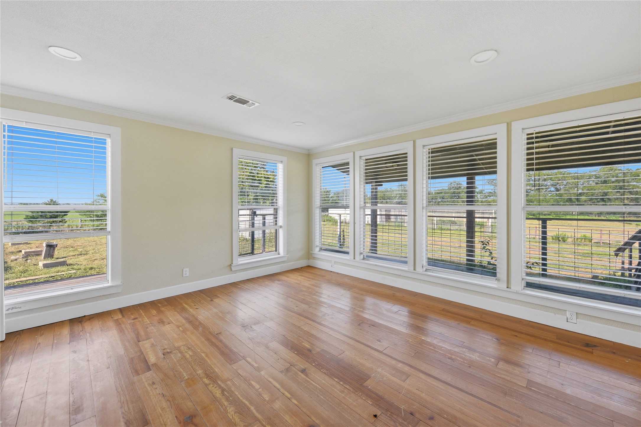 2980 Rabbs Prairie Road La Grange, TX 78945 - Photo 11 of 28 Bright, naturally illuminated interior with gleaming hardwood floors offers panoramic views of the expansive outdoors.
