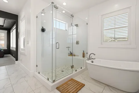a bathroom with a bathtub shower and a toilet