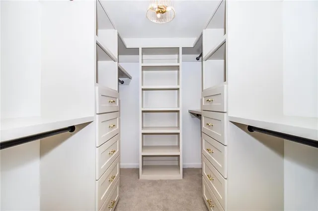a view of walk in closet with empty racks