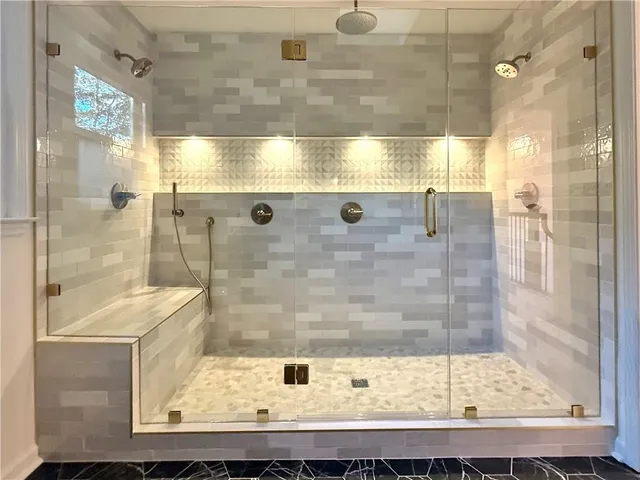 a bathroom with a shower and a sink