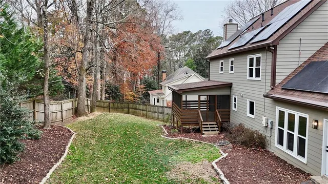 a view of a house with backyard and sitting area