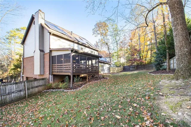 a view of house with a yard