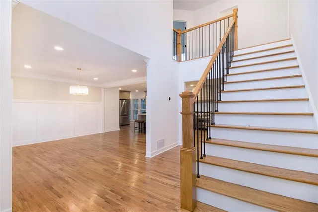 a view of entryway and hall with wooden floor