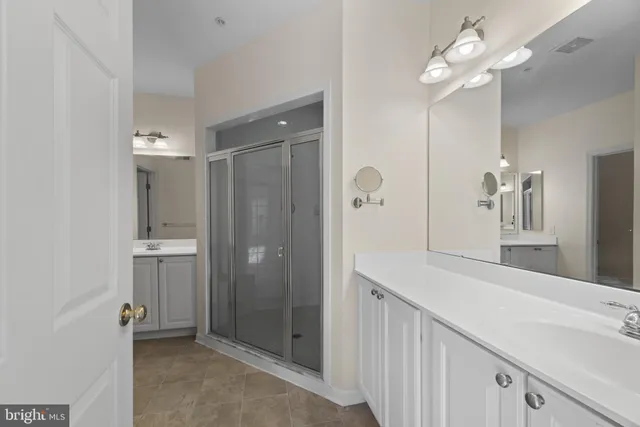 a bathroom with a shower a sink and a mirror