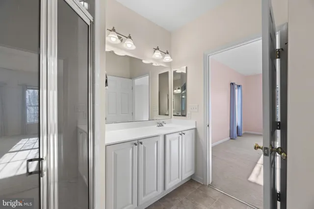 a bathroom with a double vanity sink and mirror