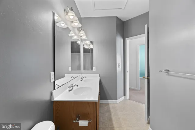 a bathroom with a sink vanity and mirror