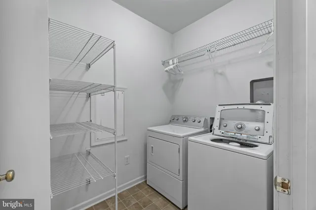 a utility room with cabinets washer and dryer