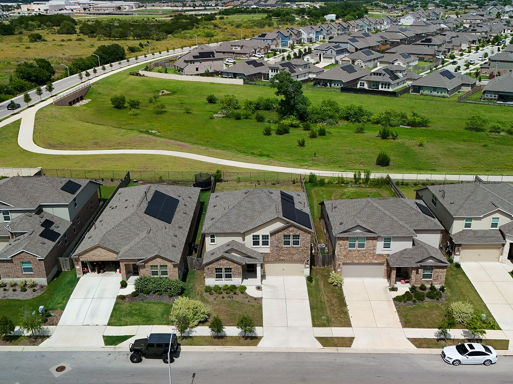 1716 Frontenac Street Leander, TX 78641 - Photo 2 of 34 an aerial view of residential houses with outdoor space and swimming pool